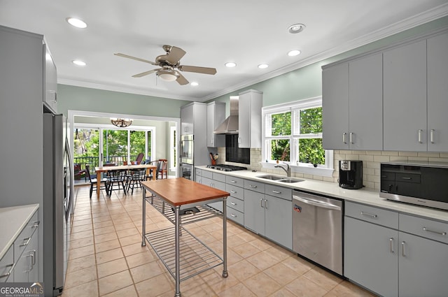 804 Eagleview, Anderson, SC 29625 - kitchen featuring stainless steel appliances, gray cabinetry, wall chimney range hood, decorative backsplash, and crown molding
