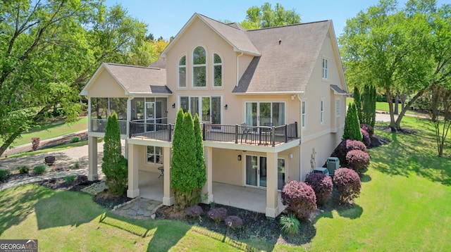 804 Eagleview, Anderson, SC 29625 - back of house featuring stucco siding, a sunroom, a patio area, a shingled roof, and a lawn