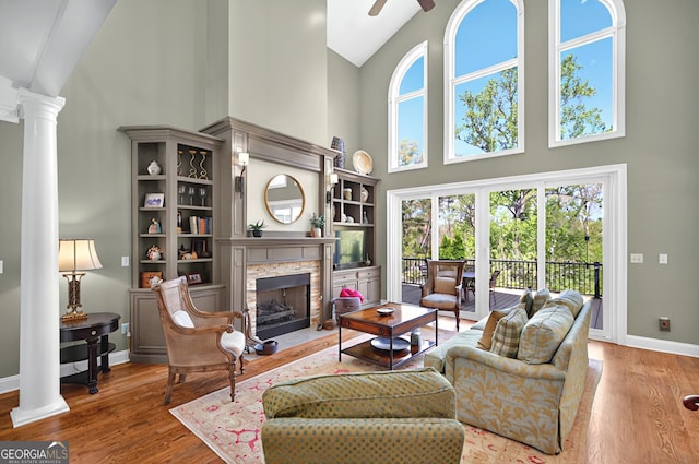 804 Eagleview, Anderson, SC 29625 - living room with high vaulted ceiling, ornate columns, a fireplace, ceiling fan, and wood finished floors