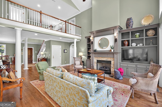 804 Eagleview, Anderson, SC 29625 - living room with a high ceiling, ornate columns, wood finished floors, a stone fireplace, and crown molding