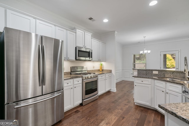 328 Spence Cir, Ball Ground, GA 30107 - kitchen featuring appliances with stainless steel finishes, ornamental molding, white cabinetry, a chandelier, and recessed lighting