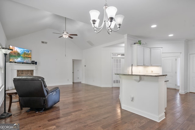 328 Spence Cir, Ball Ground, GA 30107 - kitchen featuring a ceiling fan, open floor plan, light stone countertops, white cabinets, and a kitchen bar