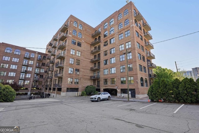 view of building exterior with uncovered parking