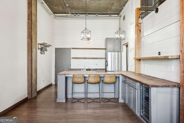 laundry area with electric water heater, washer and dryer, and cabinet space