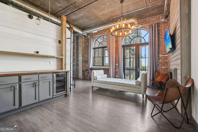 exterior space featuring brick wall and wood finished floors