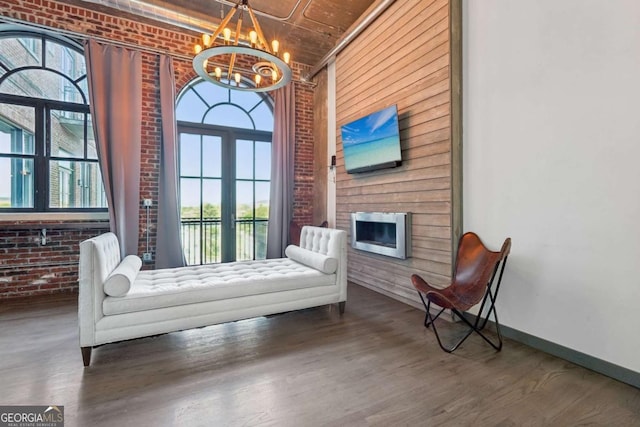 corridor featuring a sink, brick wall, a barn door, and wood finished floors