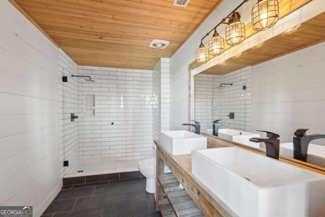 full bath featuring toilet, a shower stall, and wooden ceiling
