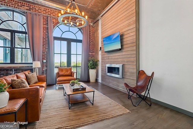 interior space with brick wall, an inviting chandelier, wood finished floors, and wine cooler