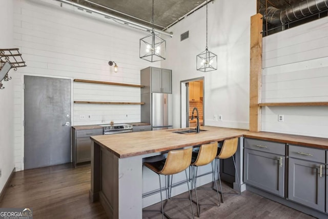 interior space featuring brick wall, beverage cooler, a chandelier, and wood finished floors