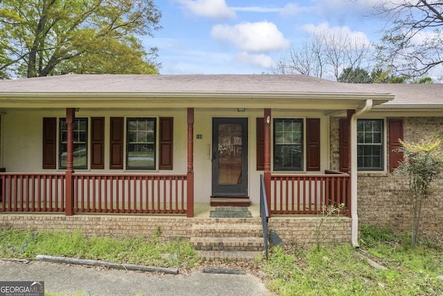 view of front of property with a porch and a shingled roof