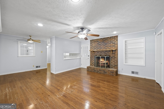 unfurnished living room with built in shelves, visible vents, and a ceiling fan