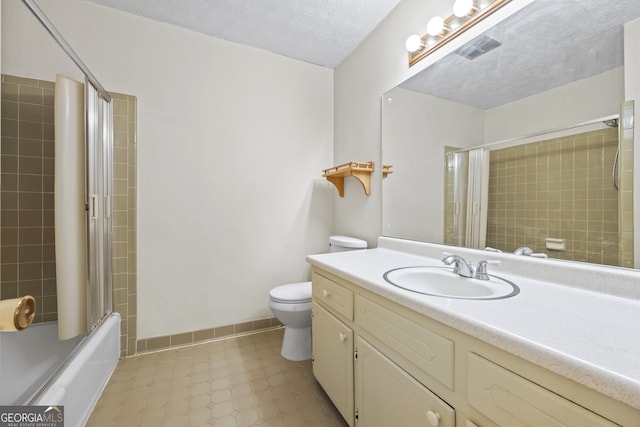 full bath featuring shower / bath combination with glass door, vanity, a textured ceiling, toilet, and visible vents