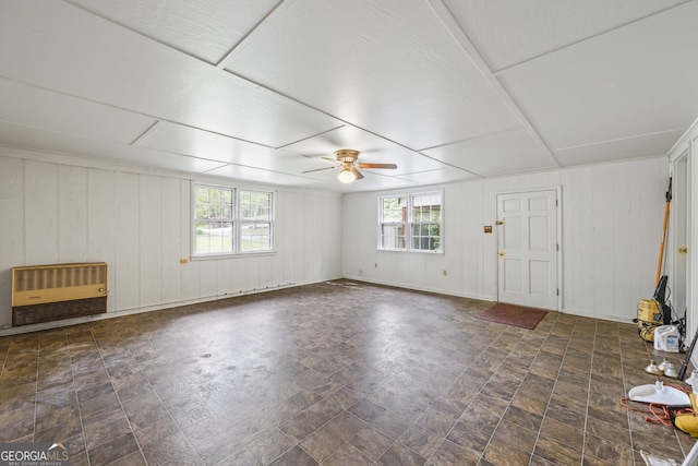 interior space with heating unit and ceiling fan