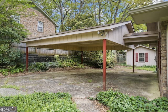 view of parking featuring a storage shed and fence