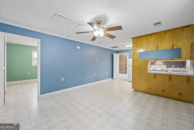 unfurnished living room featuring visible vents, attic access, light floors, and ceiling fan