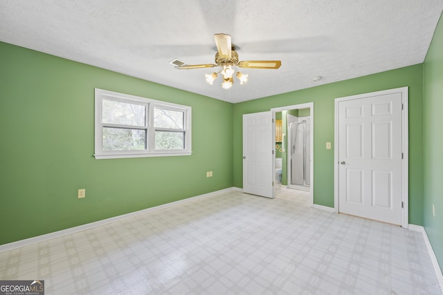 unfurnished bedroom featuring baseboards, tile patterned floors, a textured ceiling, visible vents, and ceiling fan