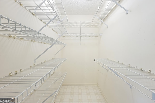 spacious closet featuring tile patterned floors