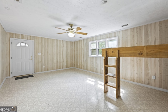 foyer featuring tile patterned floors, visible vents, baseboards, and ceiling fan