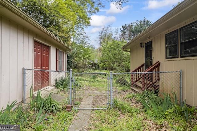 view of yard with fence and a gate