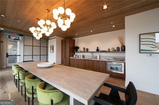 dining space with recessed lighting, wooden ceiling, a chandelier, and wood finished floors