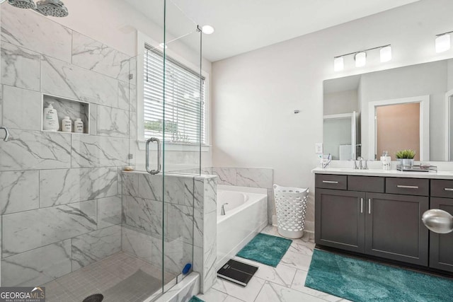 bathroom featuring a shower stall, vanity, marble finish floor, and a garden tub