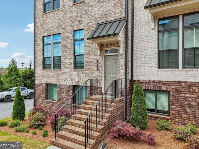 property entrance featuring brick siding