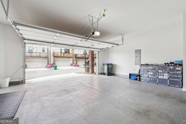 garage with a garage door opener and electric panel