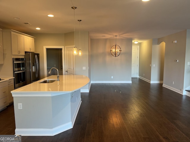 155 Martello Rd, Pooler, GA 31322 - kitchen with arched walkways, a sink, appliances with stainless steel finishes, dark wood finished floors, and a center island with sink