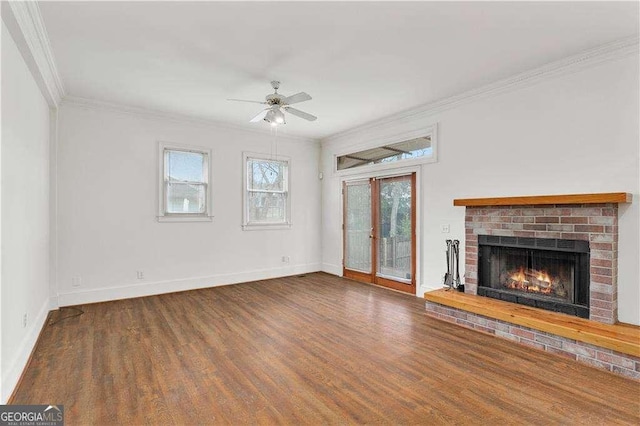 873 Monroe Cir NE, Atlanta, GA 30308 - unfurnished living room featuring crown molding, a brick fireplace, a ceiling fan, and wood finished floors