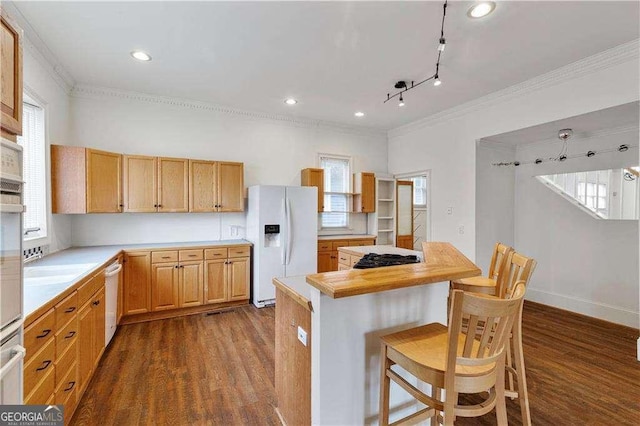 873 Monroe Cir NE, Atlanta, GA 30308 - kitchen with light countertops, a kitchen bar, white fridge with ice dispenser, and dark wood-style floors