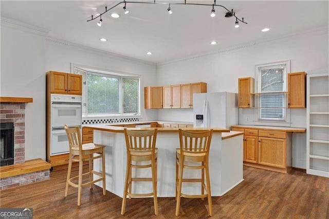 873 Monroe Cir NE, Atlanta, GA 30308 - kitchen featuring a center island, white appliances, dark wood-style floors, and light countertops