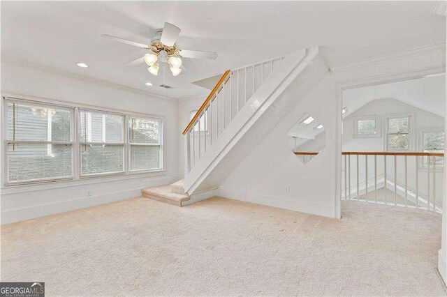 873 Monroe Cir NE, Atlanta, GA 30308 - unfurnished living room with crown molding, a ceiling fan, carpet, and stairway
