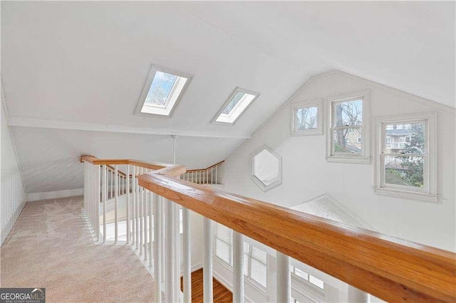 873 Monroe Cir NE, Atlanta, GA 30308 - corridor featuring vaulted ceiling with skylight, baseboards, and carpet floors