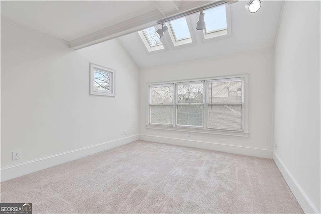873 Monroe Cir NE, Atlanta, GA 30308 - unfurnished room featuring vaulted ceiling with skylight, baseboards, and carpet flooring