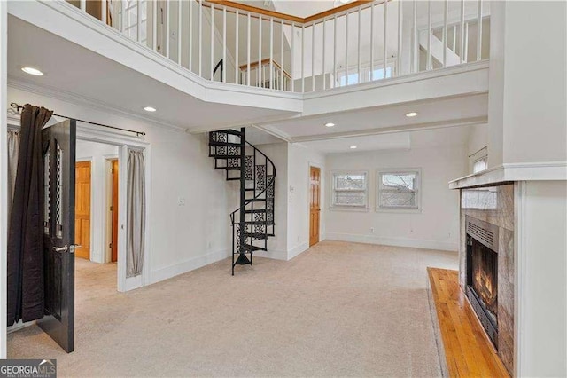 873 Monroe Cir NE, Atlanta, GA 30308 - carpeted living room with a warm lit fireplace, recessed lighting, a high ceiling, stairs, and baseboards