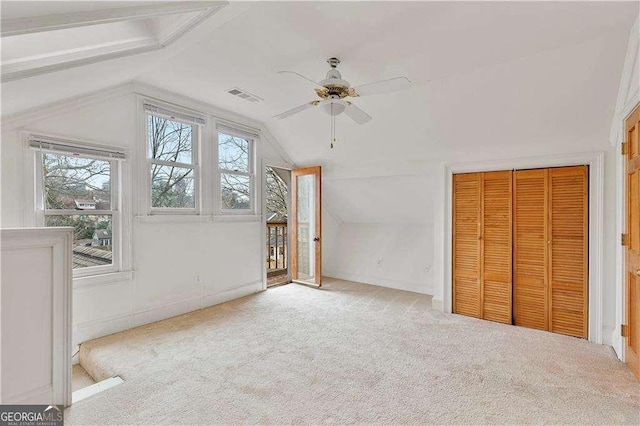 873 Monroe Cir NE, Atlanta, GA 30308 - interior space with a ceiling fan, vaulted ceiling, visible vents, carpet flooring, and baseboards