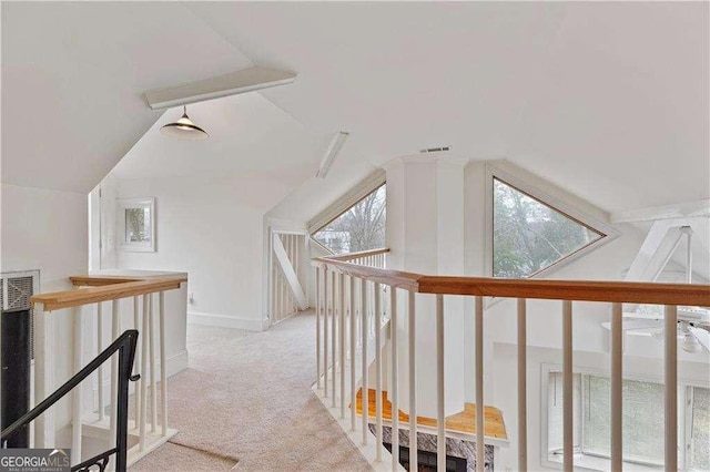 873 Monroe Cir NE, Atlanta, GA 30308 - corridor with a healthy amount of sunlight, an upstairs landing, lofted ceiling, and carpet floors
