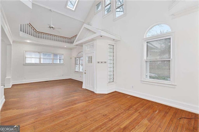 873 Monroe Cir NE, Atlanta, GA 30308 - unfurnished living room with baseboards, high vaulted ceiling, and hardwood / wood-style flooring