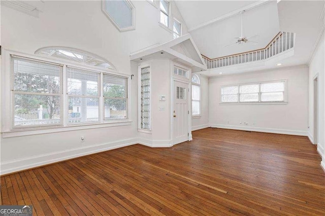 873 Monroe Cir NE, Atlanta, GA 30308 - unfurnished living room with plenty of natural light, wood-type flooring, baseboards, and a ceiling fan