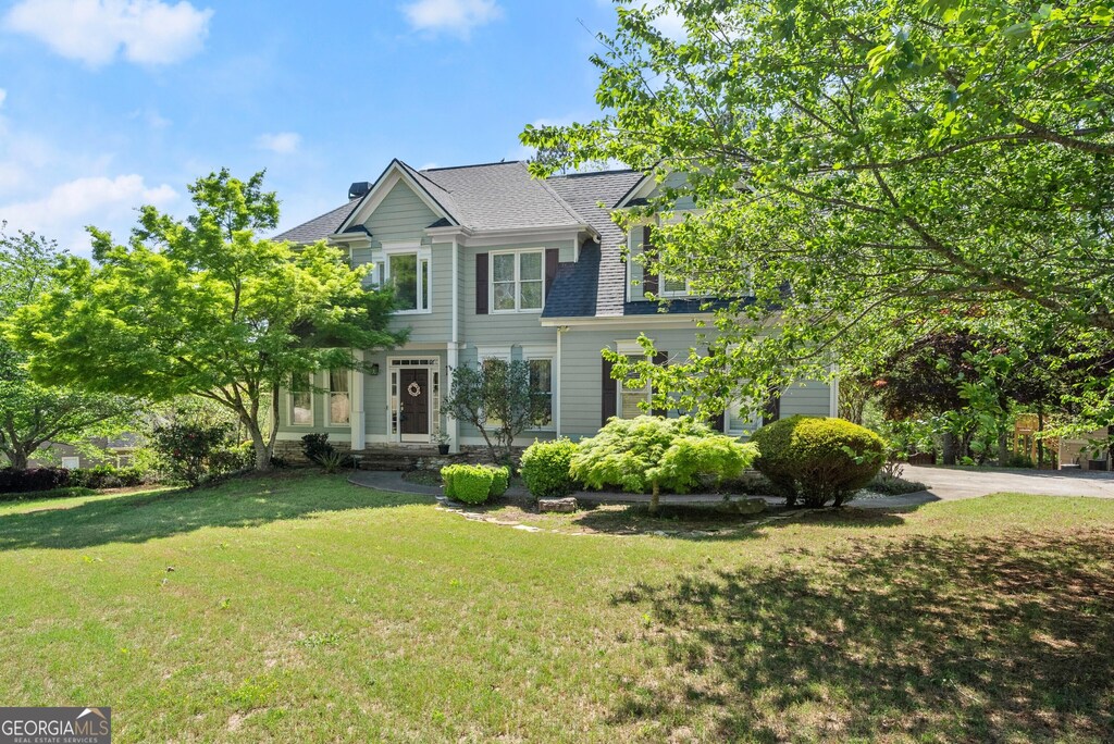 5381 Fawn Meadow Ln, Powder Springs, GA 30127 - view of front of property with a front lawn and a shingled roof