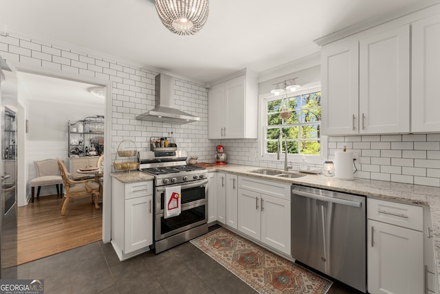 503 Duke Dr, Marietta, GA 30066 - kitchen with crown molding, wall chimney range hood, a sink, dark tile patterned floors, and stainless steel appliances