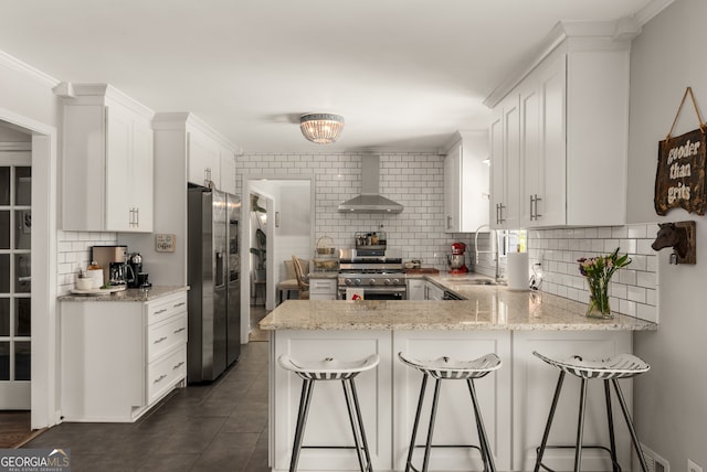 503 Duke Dr, Marietta, GA 30066 - kitchen with a sink, wall chimney range hood, a peninsula, stainless steel appliances, and decorative backsplash