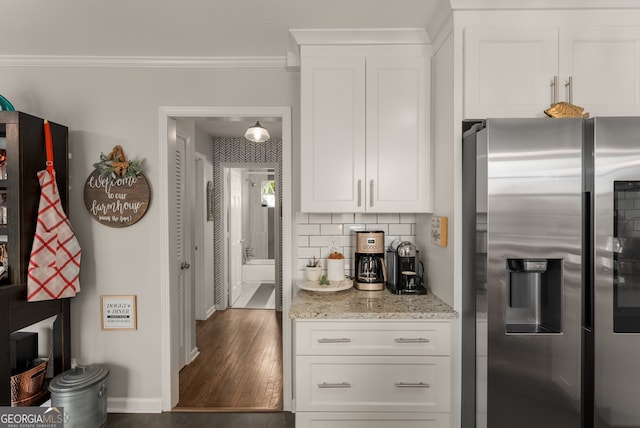 503 Duke Dr, Marietta, GA 30066 - kitchen featuring crown molding, stainless steel fridge with ice dispenser, light stone countertops, tasteful backsplash, and wood finished floors