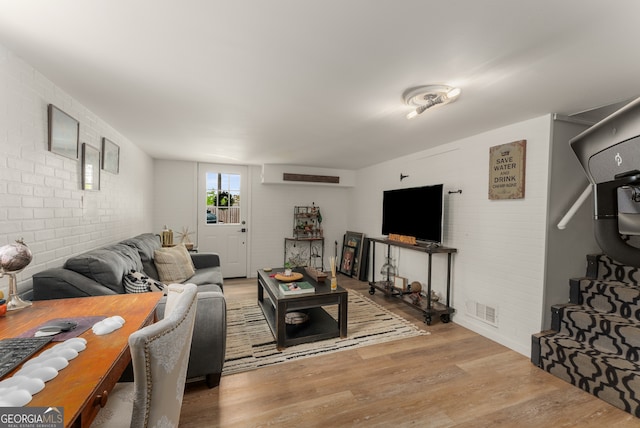 503 Duke Dr, Marietta, GA 30066 - living room with wood finished floors, brick wall, and visible vents