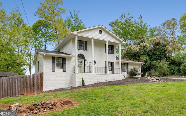 503 Duke Dr, Marietta, GA 30066 - neoclassical / greek revival house featuring a porch, brick siding, fence, and a front lawn