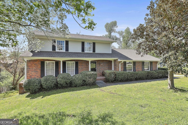31 Festiva Dr, Newnan, GA 30263 - traditional home featuring brick siding, a front yard, and roof with shingles