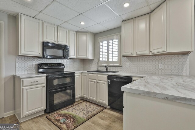 31 Festiva Dr, Newnan, GA 30263 - kitchen with light countertops, light wood-type flooring, and black appliances