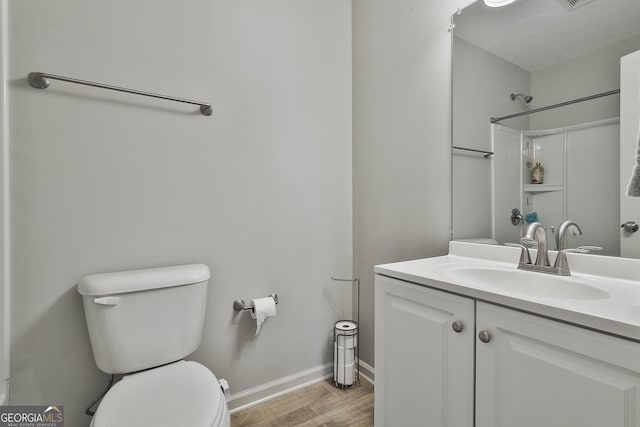 31 Festiva Dr, Newnan, GA 30263 - bathroom featuring vanity, baseboards, toilet, and wood finished floors