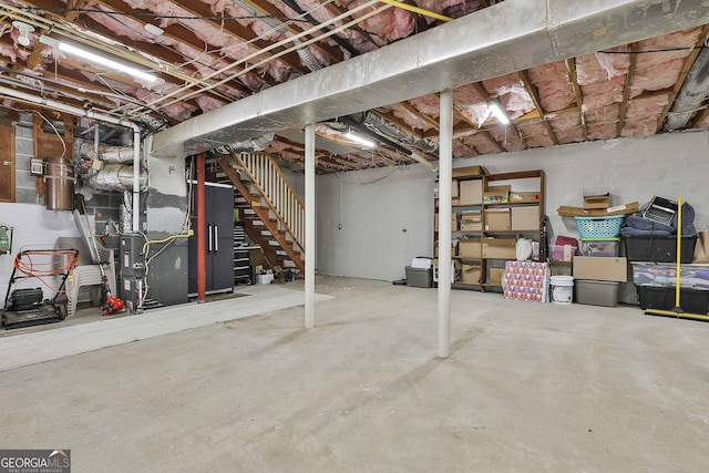 31 Festiva Dr, Newnan, GA 30263 - unfinished below grade area featuring heating unit, concrete block wall, and stairway