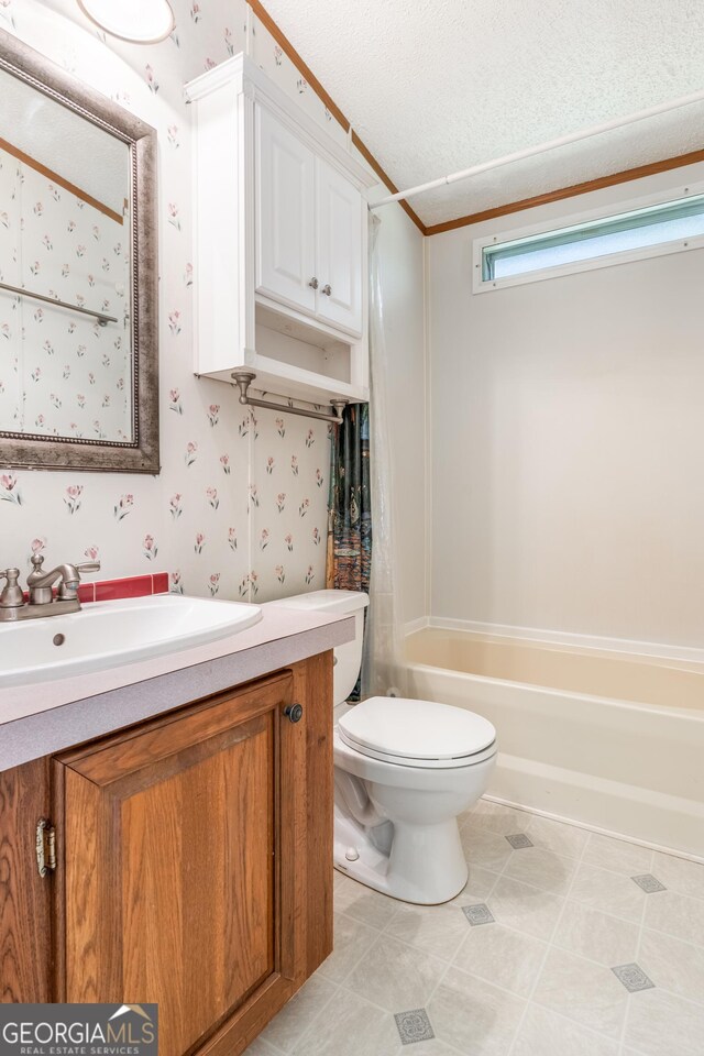 bathroom featuring wallpapered walls, toilet, vanity, and bathtub / shower combination